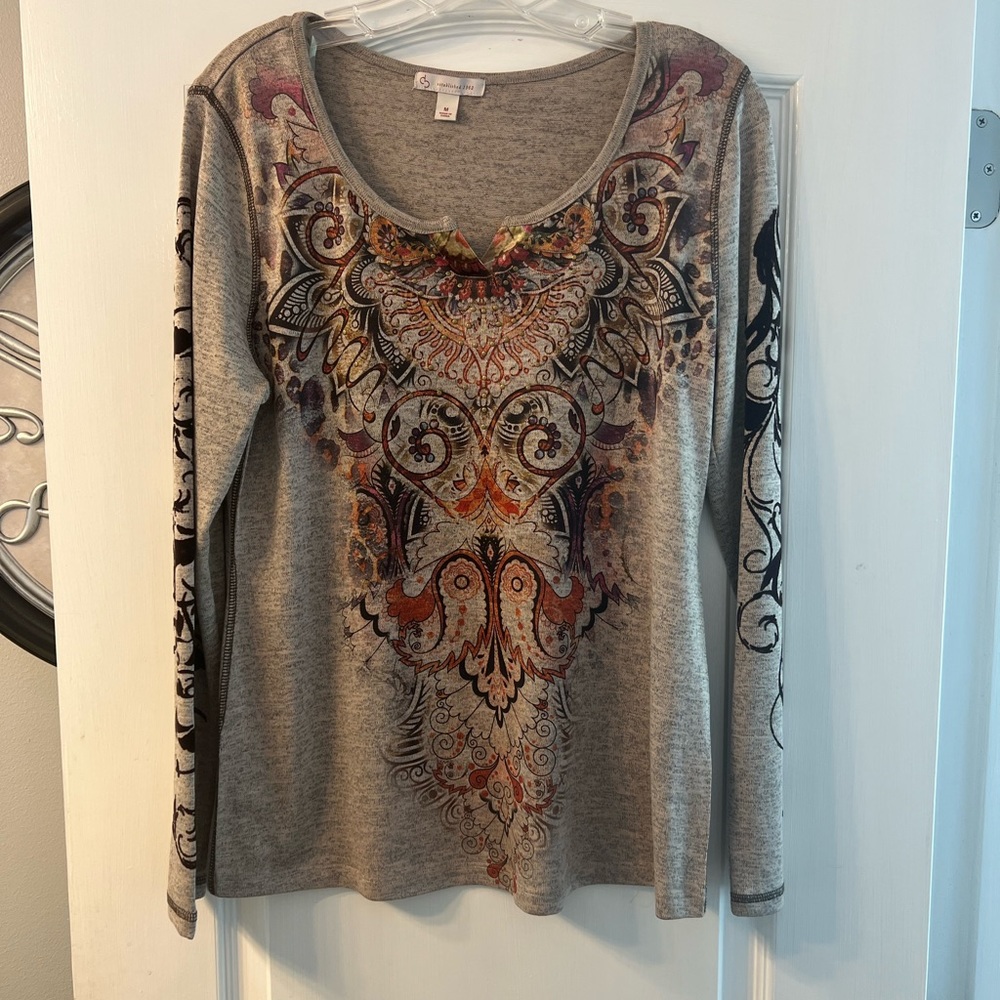 Tan long sleeve with graphic print and studs size M Established 1962